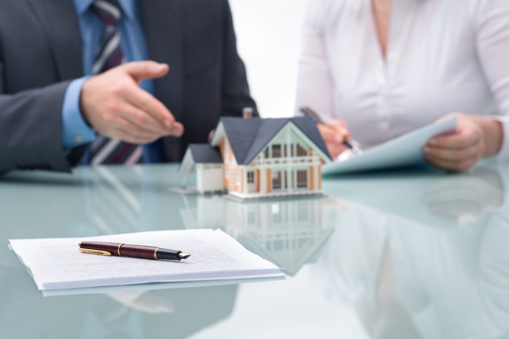 A businessman discusses real estate with a client